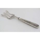 A Victorian silver bread / serving fork  with shaped tines. Hallmarked  1857 maker Atkin Brothers