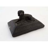 A Regency formed leather paperweight depicting reclining dog on a shaped squared base. 4 1/4" x 2