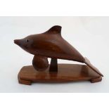 A 20thC carved hardwood depiction of a leaping dolphin on base 12" long x 7 1/2" high  CONDITION: