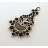 Mourning Jewellery : A 19thC mourning pendant with lock of hair to centre bordered by black Whitby