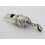 A white metal whistle with dog head decoration. Marked '925'. Approx 1 3/4" long  CONDITION: