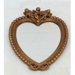 A mid 20thC gilt framed heart shaped wall minor with reeding and beaded decoration surmounted by 3