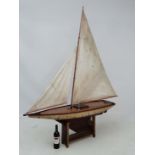 A large mid 20thC  50'' Pond Yacht on stand . Named '' Dorothy '' . Having brown painted wooden hull