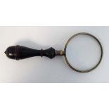 A brass magnifying glass with turned ebonised handle 6 1/4" long CONDITION: Please Note -  we do not