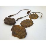 A pair of Victorian brass curtain tie backs , 2 pairs of pressed brass cartouche shaped adornments