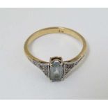 A 9ct gold ring set with marrcasite decoration to shoulder and central aquamarine like stone