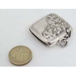 A  silver vesta case with engraved decoration, hinged lid and striker under. Hallmarked Birmingham