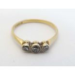 An 18ct gold ring set with trio of diamonds to top.  CONDITION: Please Note -  we do not make