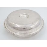 A silver plate 2- sectional entree dish of ciruclar form with cover and marked under Daniel &