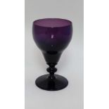 A 19thC amethyst glass wine glass. Approx 6" tall.  CONDITION: Please Note -  we do not make