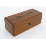 Money Box : an Edwardian mahogany Money box with two brass edged coin slots and circular key