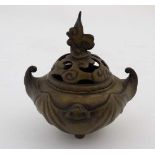 An oriental circular bellied tripod brass censor with bat decoration to sides. Approx  6" high