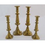 Four (2+2) c.1895 brass candlesticks with unusual skep like decoration to columns and push ejectors.