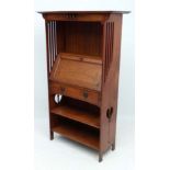 A c.1900 Art Nouveau student oak bureau bookcase with shaped top section, fall front and single