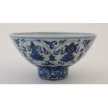 A Chinese blue and white bowl decorated with stylised images of Chrysanthemums, urns, fish and