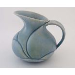 An Art Deco Crown Devon '' London '' jug. Decorated in turquoise with yellow and having moulded