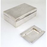 An Art Deco silver table top cigar / cigarette case with engine turned decoration and monogram to
