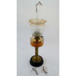A late 19thC oil lamp with brass reeeded column, twin burner and etched shade together with three