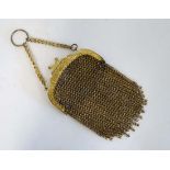 A c1900 Ladies gilt brass chain mail purse with finger ring, decorative detail to top of purse and