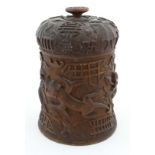 An unusual 119thC Burmese carved wooden tobacco pot  decorated with dragons, figures, flower etc 9