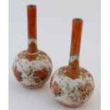 A pair of small Japanese Kutani bottle vases. Decorated with floral and foliate details in Kutani