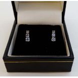 A pair of earrings each set with 3 graduated Tanzanites? and marked 10k Mexico  CONDITION: Please