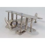 A 1930s chromium plated desk model of an early 20th C Bi-Plane on skids. 11'' long x 5'' high