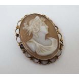 A cameo brooch depicting a classical figure within a a 9ct gold mount 1 1/4" long CONDITION: