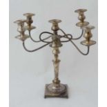 A silver plate 5 branch candelabra on a squared base with 4 ball feet Approx 19" high  CONDITION: