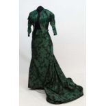A Green and black ladies silk Victorian jacket and skirt with green velvet detail to yolk of