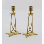 Arts and Crafts : an Art Nouveau style pair of brass candlesticks , possibly by Archibald Knox (
