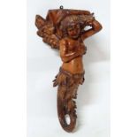 A 19thC carved pine figurehead / caryatid wall bracket in the form of a winged mermaid with acanthus