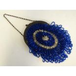 A c1920's ladies glass bugle bead purse in blue and silver with fringe detail, metal frame with