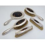 A 5-piece silver dressing table set comprising hand mirror and 4 brushes (2+2) all with inset