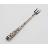A small pickle fork with white metal handle with embossed floral decoration 4 3/4" long   CONDITION: