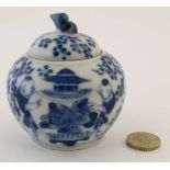 A small Chinese style blue and white lidded pot, decorated with figures and foliate detail, the