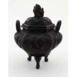 A cast bronze hexagonal tripod lidded censor with four character mark under and scrolling dragons to