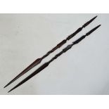 Native Tribal : 2 mid 20th C African carved hard wood spears each with 2 African mask motifs