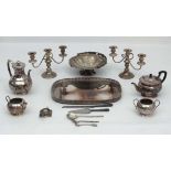 A quantity of assorted silver plated wares to include cake basket, galleried tray, candelabra,