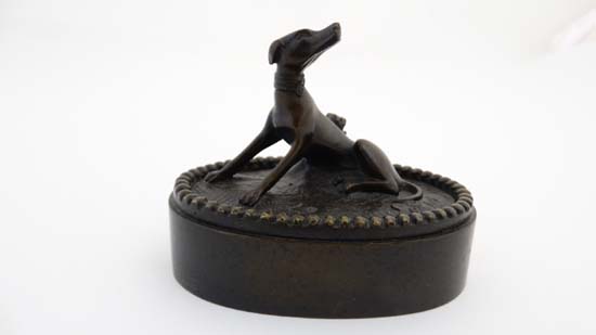 A Regency patinated bronze oval desk weight in the form of a sejant dog. 3 1/4" wide x 2 3/4" - Image 3 of 6