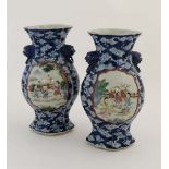 A pair of Chinese blue and white 2 handled vases with poly chrome cartouches decorated with