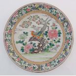 A large Oriental famille rose charger , decorated in poly chrome with birds on a flowering bough ,