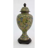 A large cloisonne vase and cover of baluster form with pedestal base on an ebonised stand. 21" high