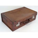 A leather travelling case with watered green silk interior and pocket to lid 21 1/2" wide