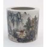 A large Chinese famille rose brush pot of cylindrical form with landscape decoration depicting a