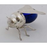 Honey pot : A late 20 thC silver plate and blue glass honey pot in the form of a bee , 6" long