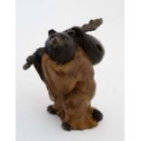 A cold painted bronze of a bear with staff and travel bag and wearing a habit 4 1/2" high