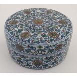 An 18thC Chinese circular lidded pot. Hand painted with floral and foliate details. Bearing