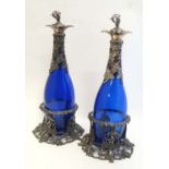 Decanters and stands : a pair of Victorian style silver plate and blue glass decanters, stands and