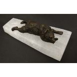 A patinated bronze figure of a recumbent bear upon a rock crystal base. 9" long  CONDITION: Please